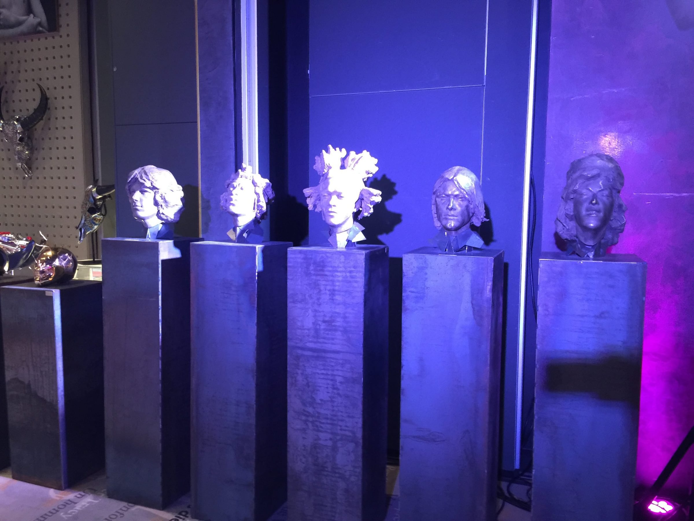Sculpted busts on plinths under blue light at the Cannes Film Festival Auction 2015, Hôtel Barrière Le Majestic