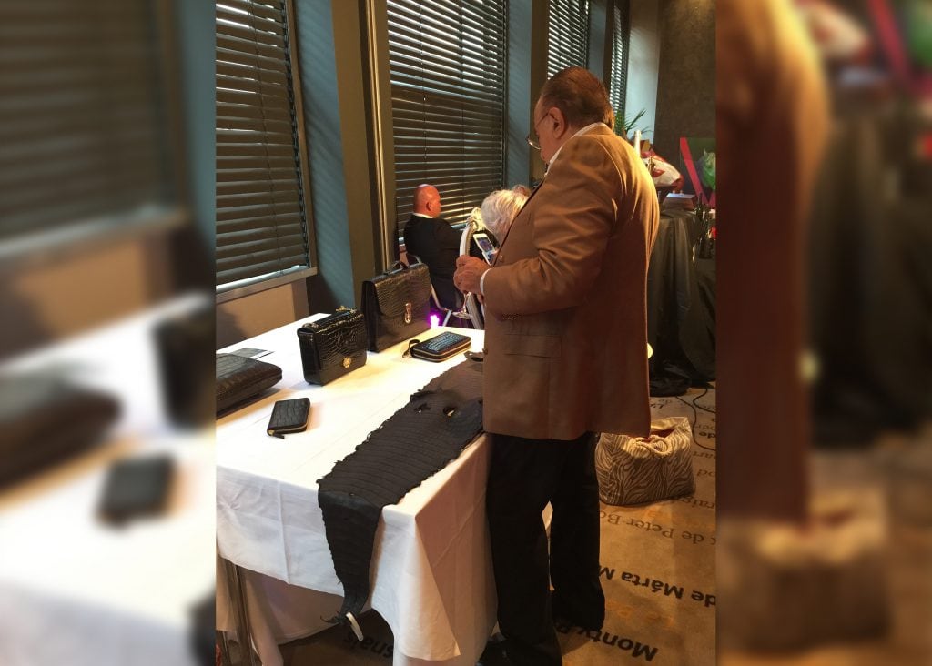 Guest inspecting the RussoBaltique caviar table at the Cannes Film Festival Auction 2015, Hôtel Barrière Le Majestic