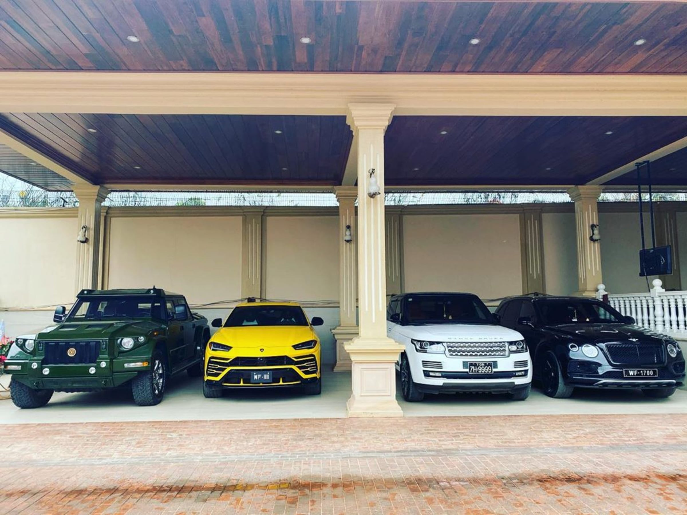 DARTZ Prombron’ parked beside a Lamborghini Urus, a Range Rover and a Bentley at a villa