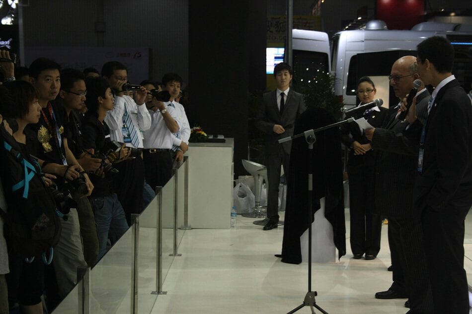 Press and guests gathered at the DARTZ stand at a motor show in China