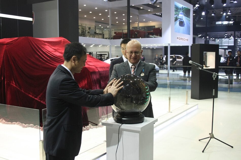 Unveiling ceremony at the DARTZ stand, beside the covered car