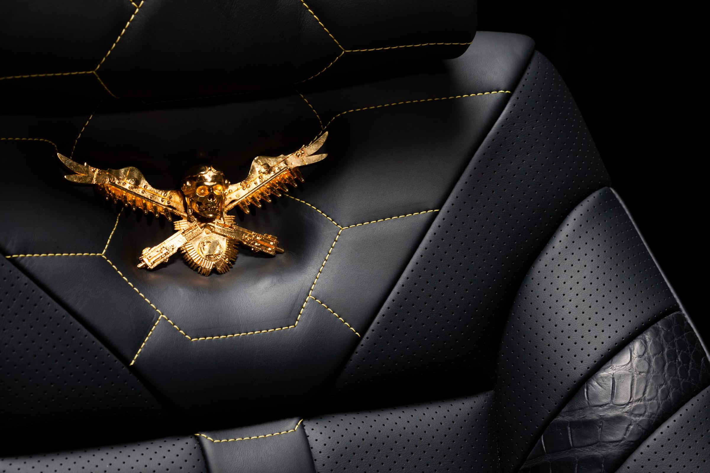 Quilted black leather DARTZ headrest with a gold double-headed eagle