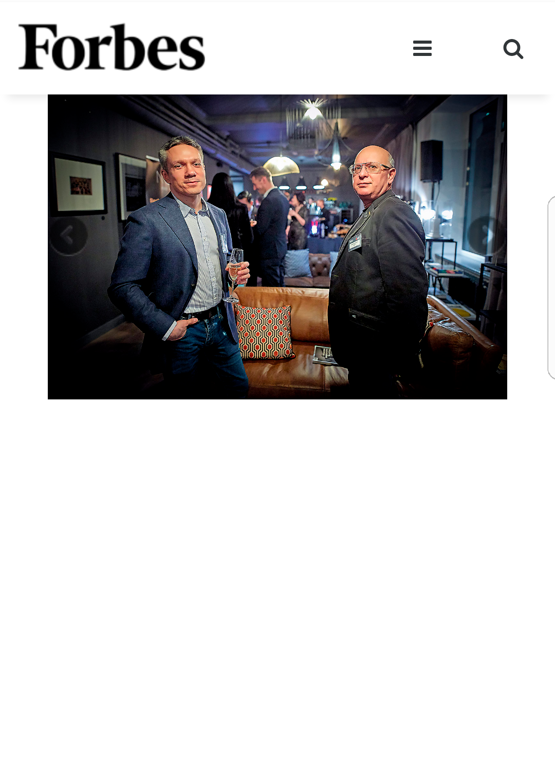 Forbes article photograph of two men in a dimly lit interior