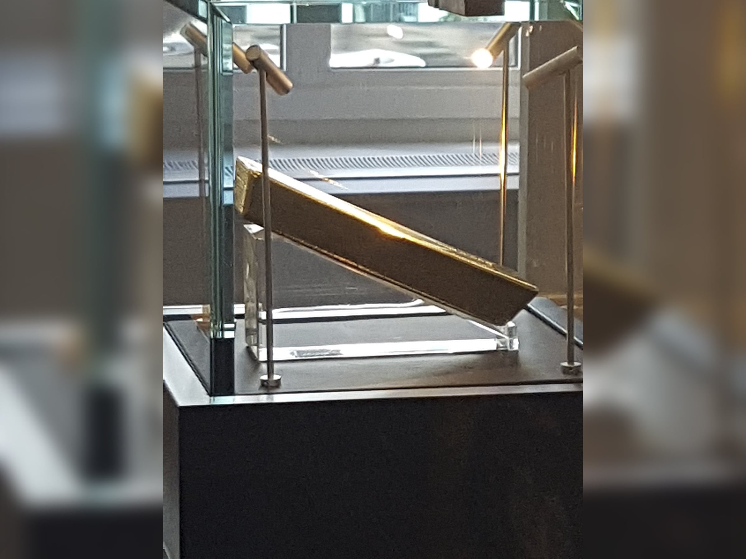 Glass vitrine with a gold-framed display cradle