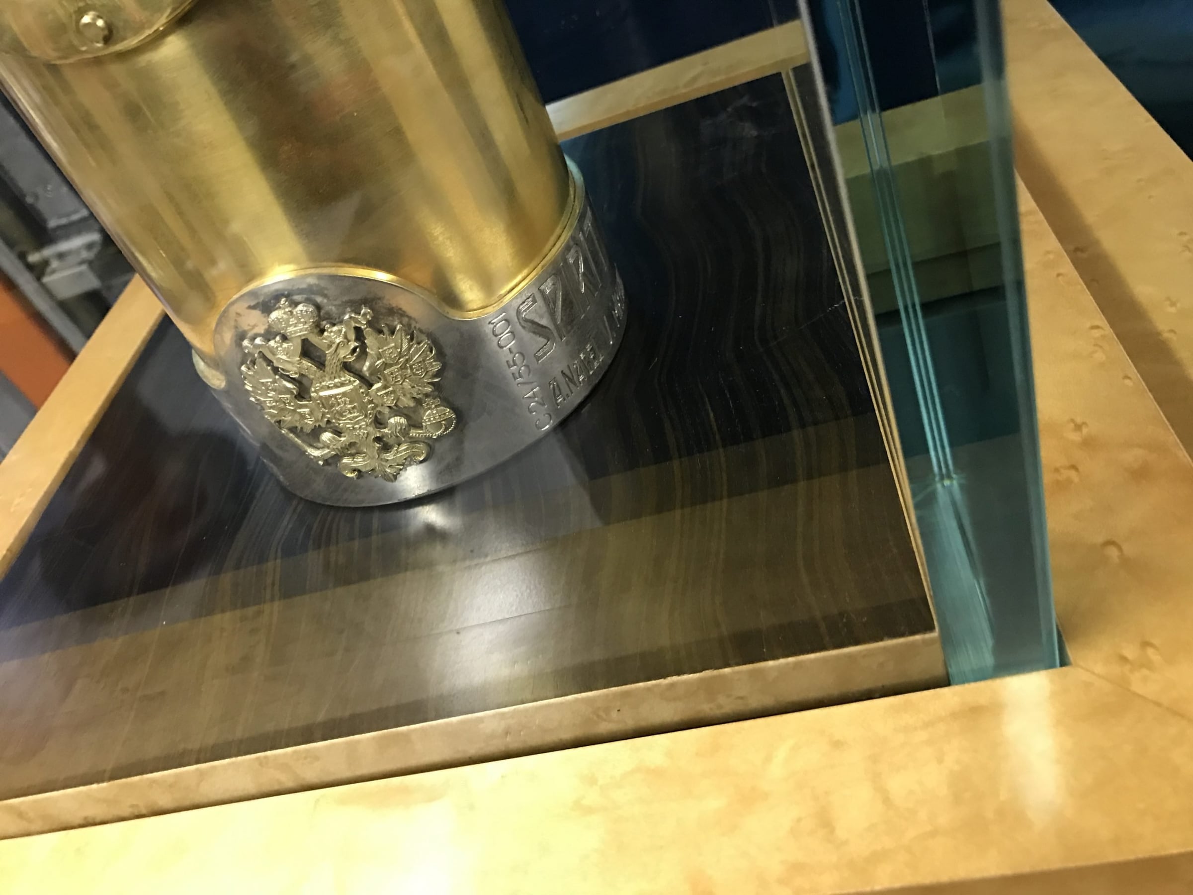 Gold object with a jewelled mount in a glass display case