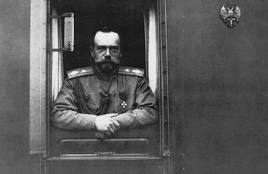 Archive photograph of an officer at a railway-carriage window, imperial eagle above