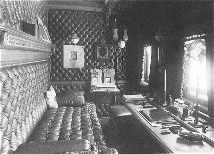 Archive photograph of a tufted leather study with a desk