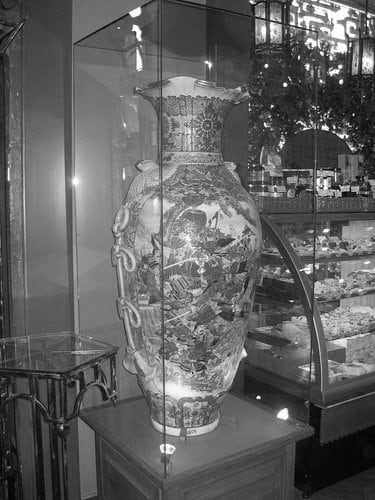 Ornate porcelain vase inside a glass display case