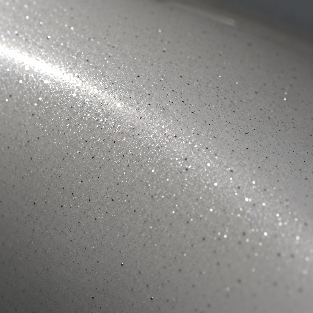 Paint with diamond dust lacquered into it, under raking light