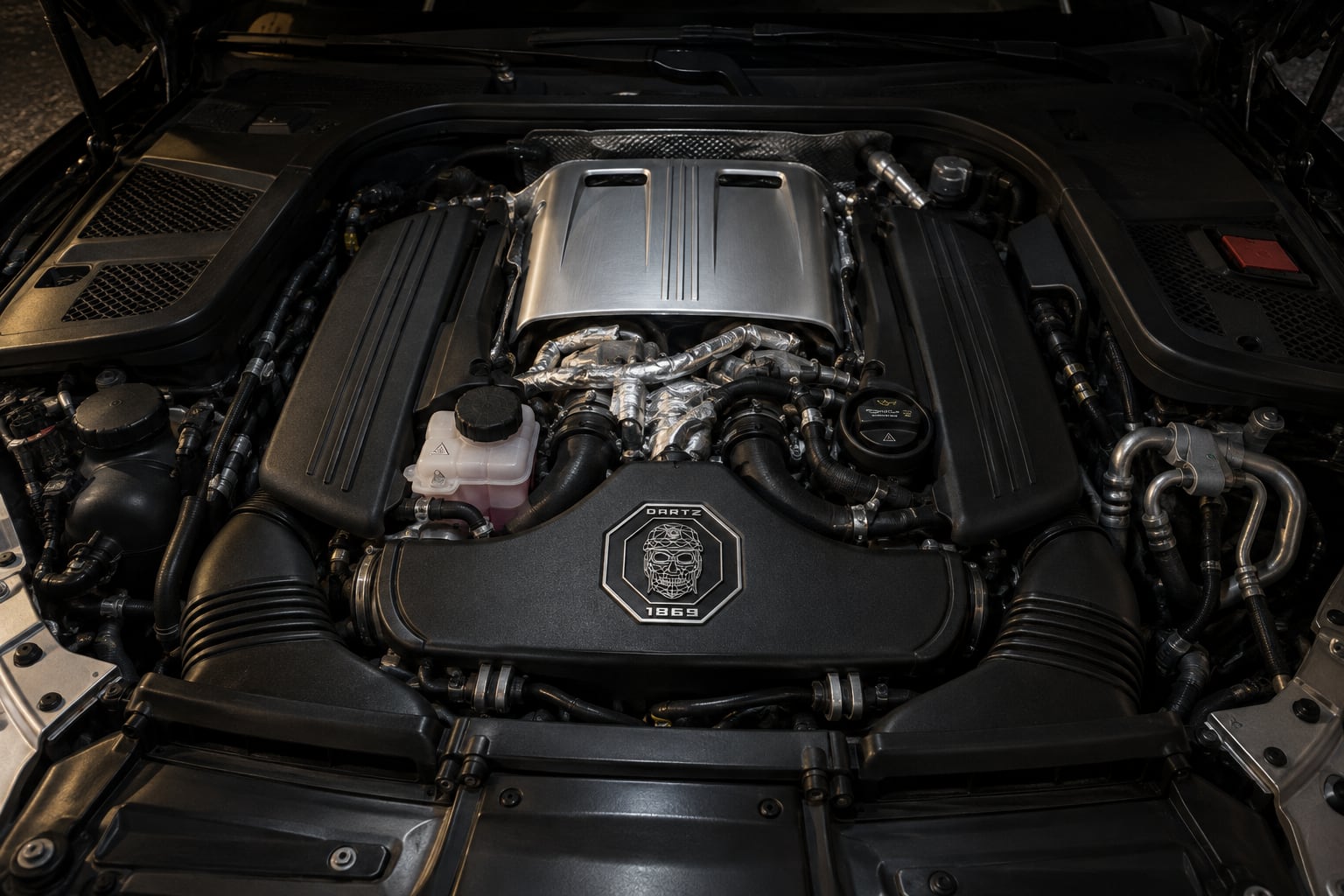 The Black Alligator’s twin-turbo V8, with the DARTZ skull crest on its cover