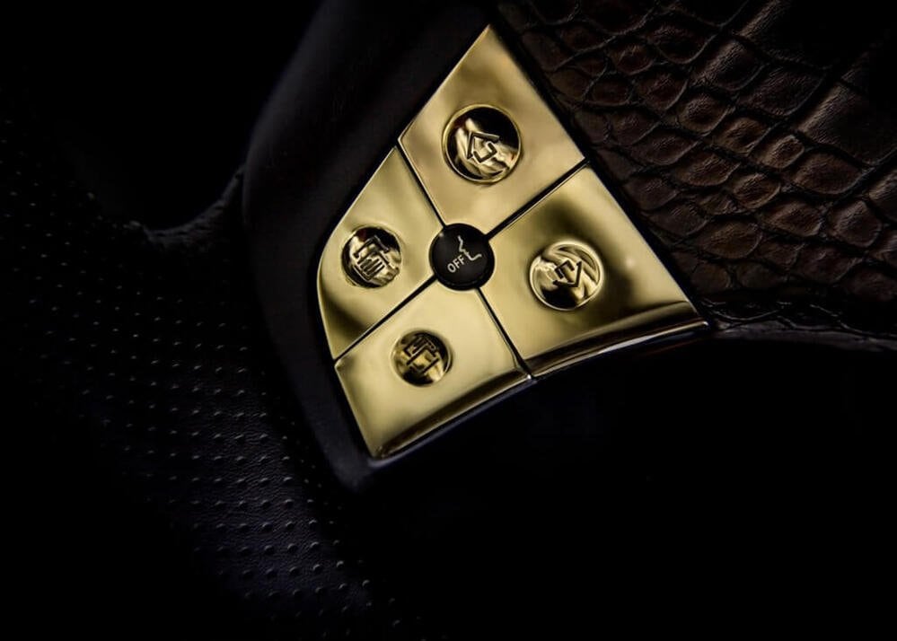 Gold steering-wheel buttons set in alligator leather on the Black Alligator