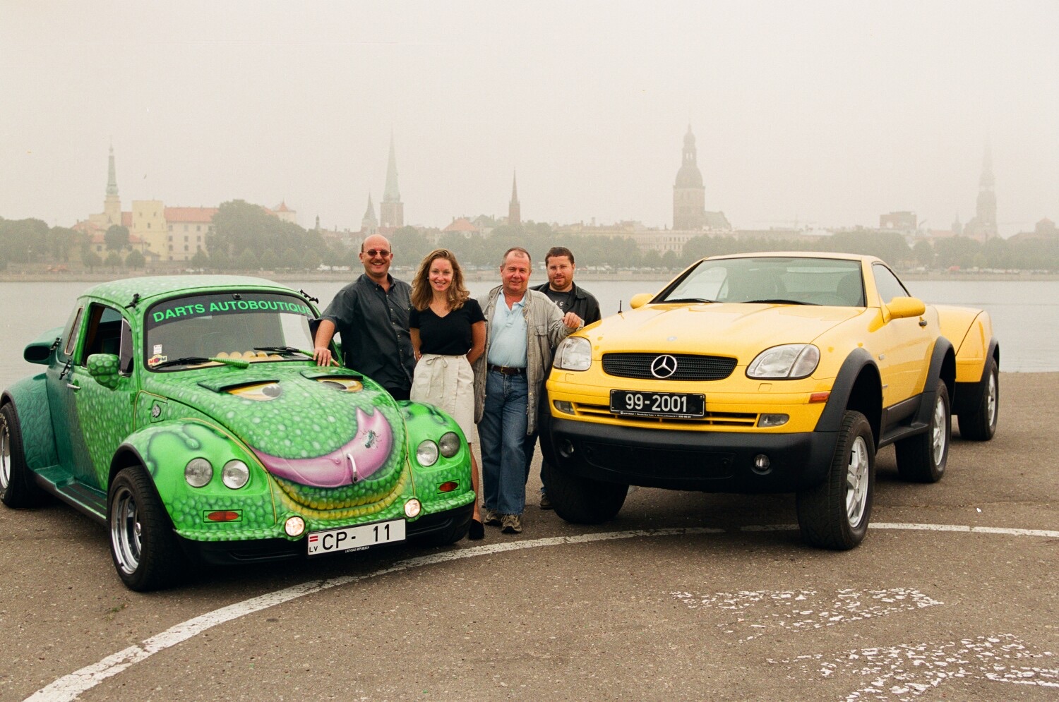The green DARTZ VW Froggy beside the River Daugava in Riga in 1999, with Leonard F. Yankelovich, Jim Rogers and Paige Parker and their Millennium Adventure Mercedes