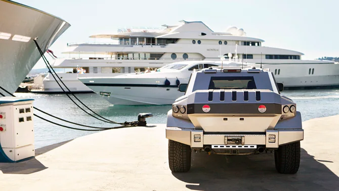 Original DARTZ Prombron’ Iron Diamond on a marina quay beside a superyacht